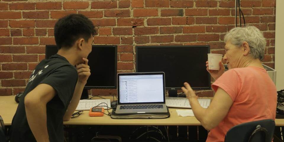 CCTV-FoundTech two people seated at a laptop