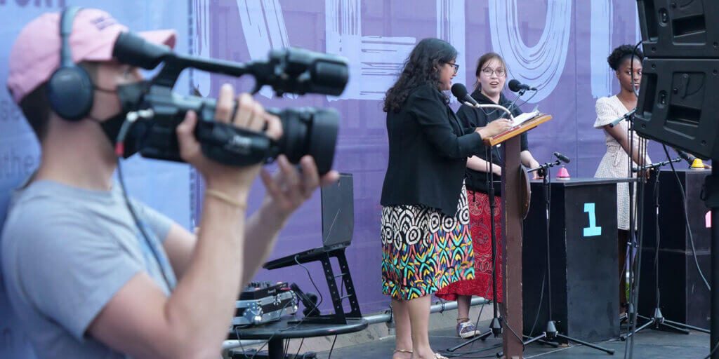 Production services shows a film crew working at a live outdoor event